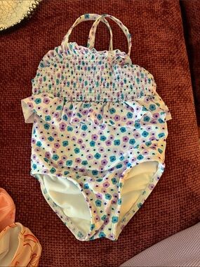 8 bathing suits total. All size 2T. You get all 8 bathing suits for the price.